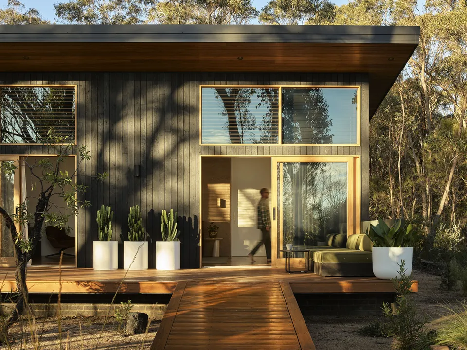 Chalet exterior with timber deck set in bushland