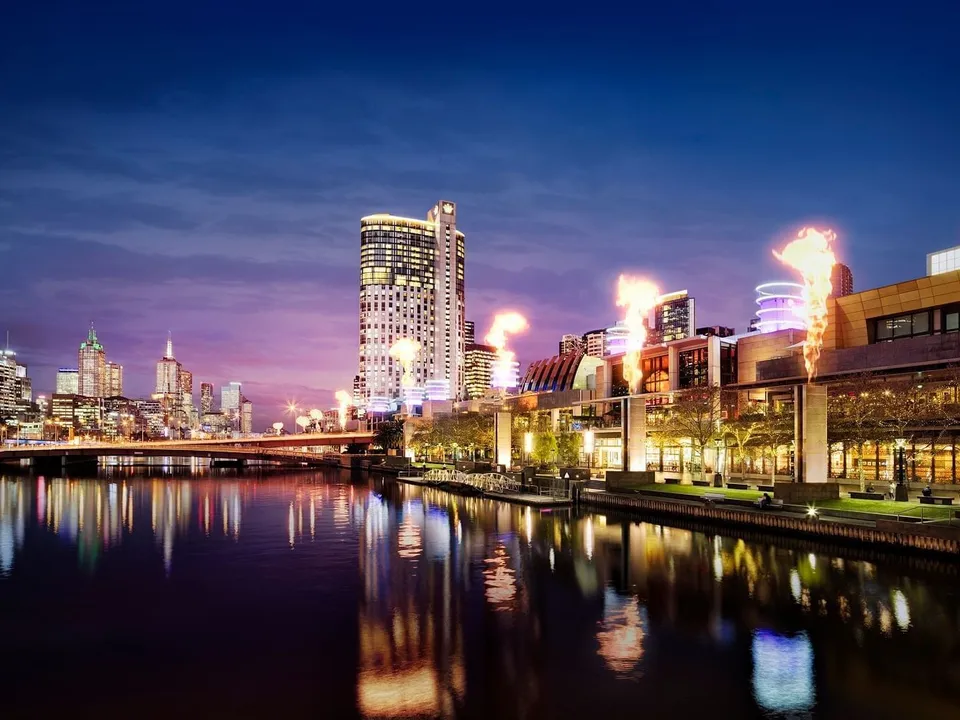 Crown Melbourne and the Yarra River at twilight, with the fire towers lighting up the Southbank skyline