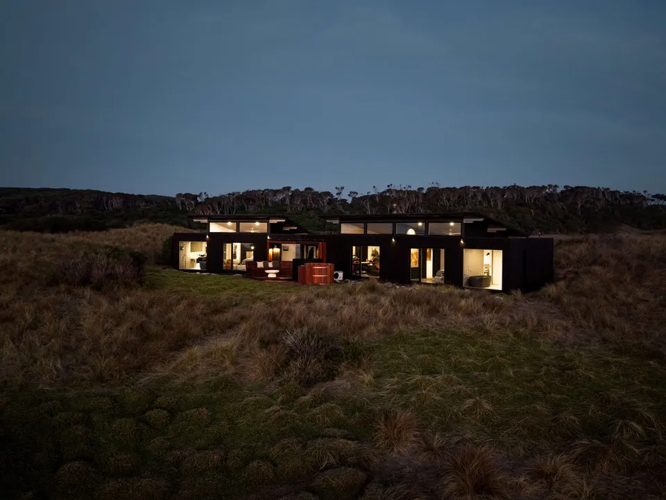 Kittawa Lodge lit at dusk in the coastal dunes