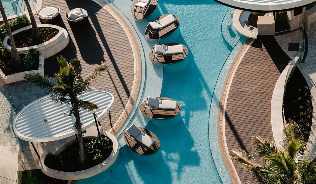 The Langham, Gold Coast: a pool with in-water loungers and curved decks