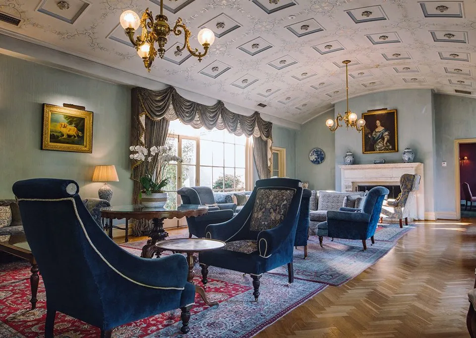 The Drawing Room with ornate plasterwork ceiling and period furnishings