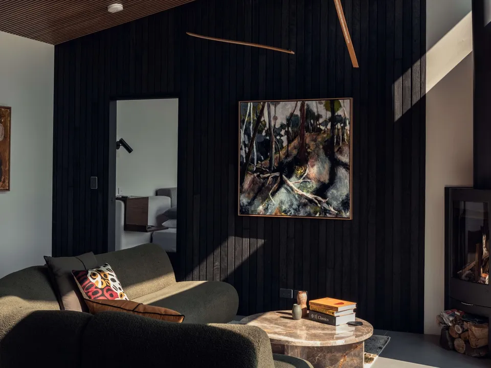 Living room with wood fireplace and local artwork