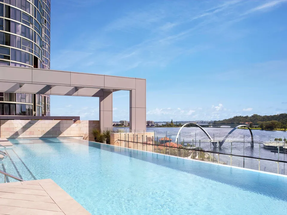 The heated outdoor infinity pool, facing the Swan River and the Elizabeth Quay Bridge