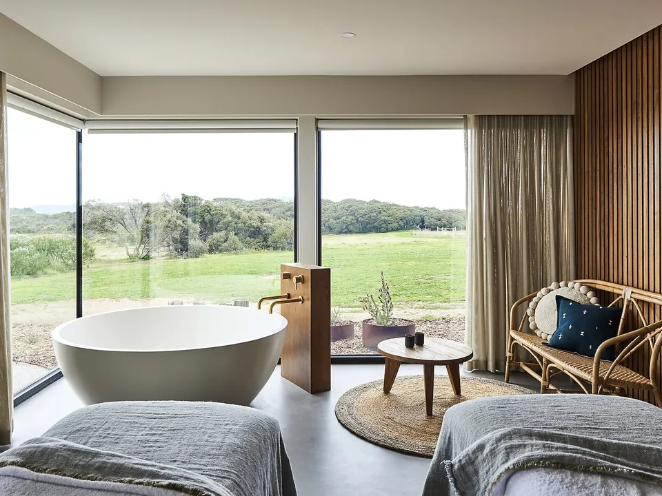 The spa treatment room with freestanding bath overlooking the farmland